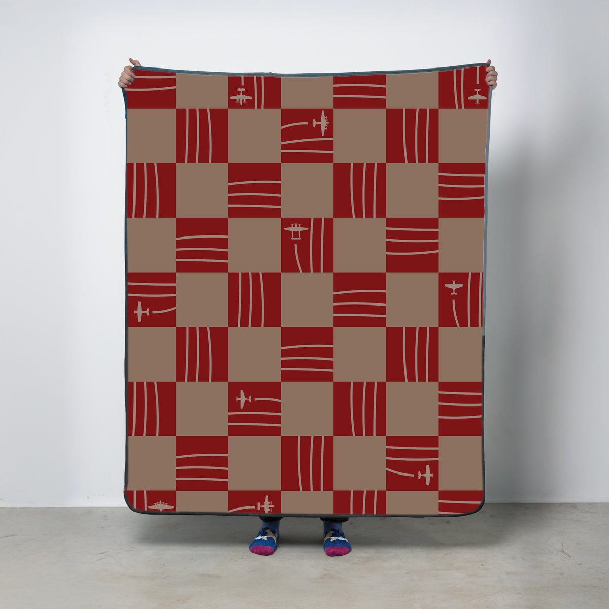 Checkered fleece blanket with vintage airplanes in rich warm tones