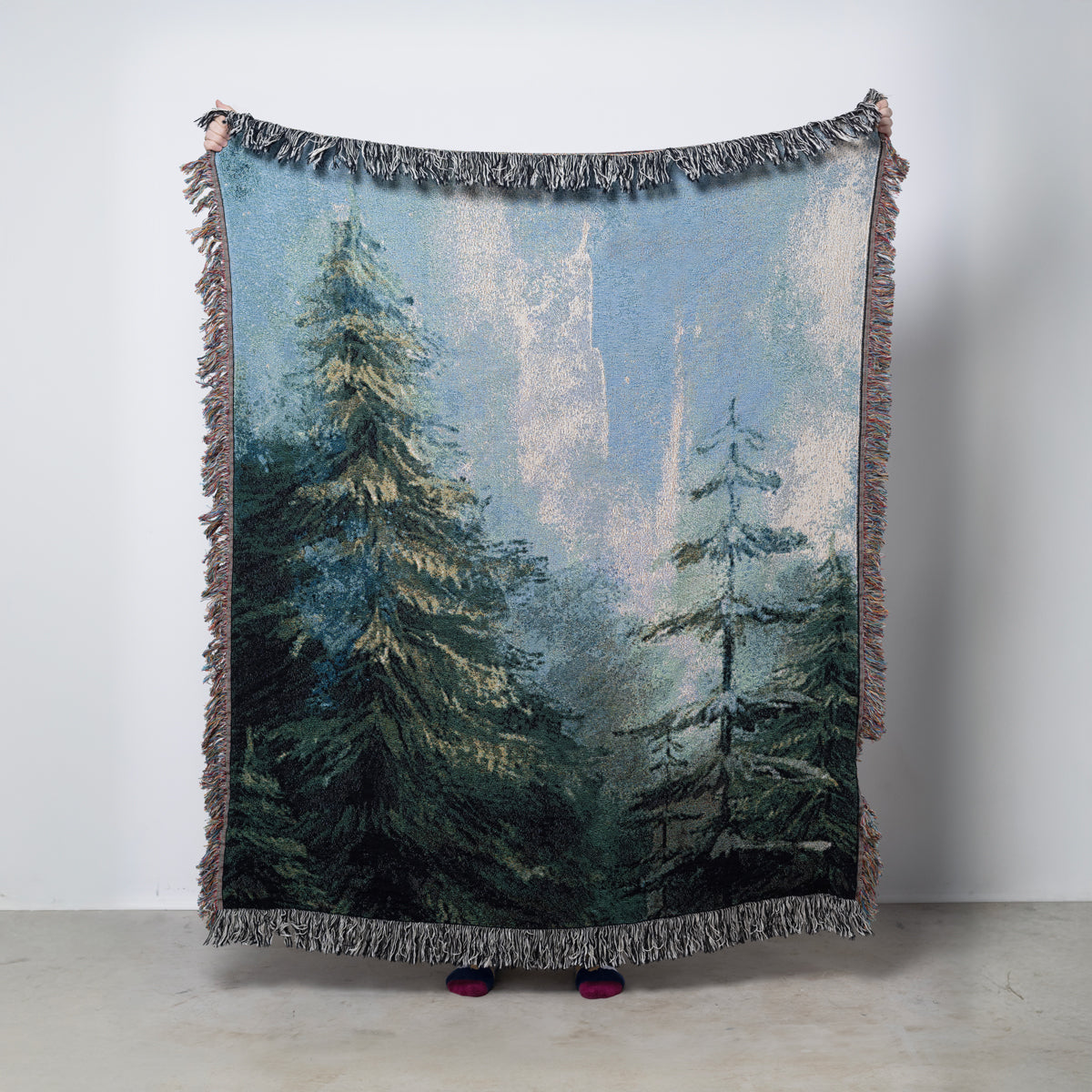 Woven-blanket with a forest design and northern lights