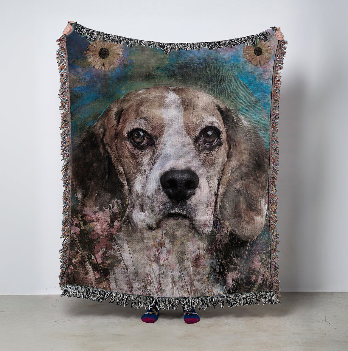 Woven blanket with a dog's face design on a plain background with flowers