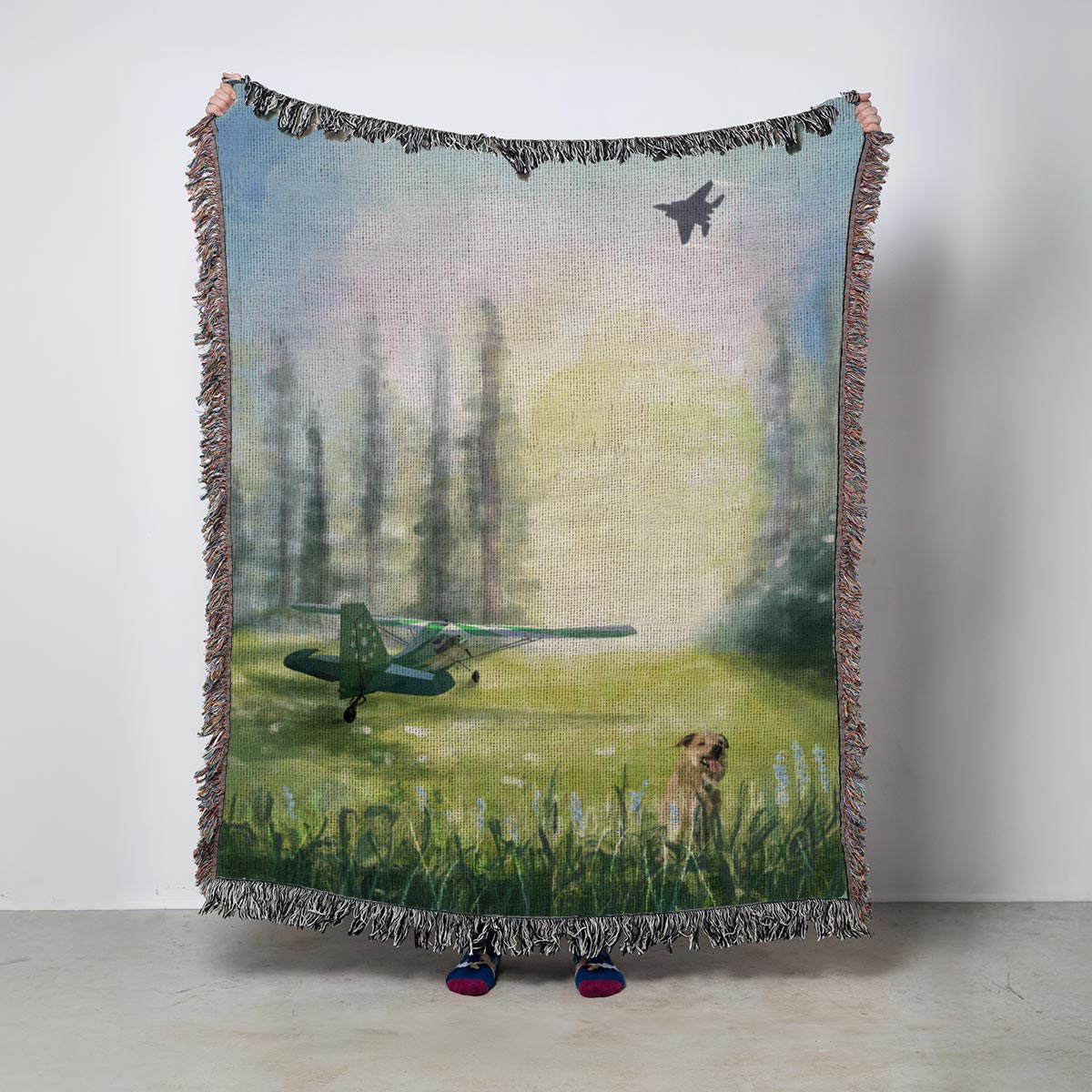 Fleece blanket with a scenic design of a dog and airplane in a field with trees and sunrise