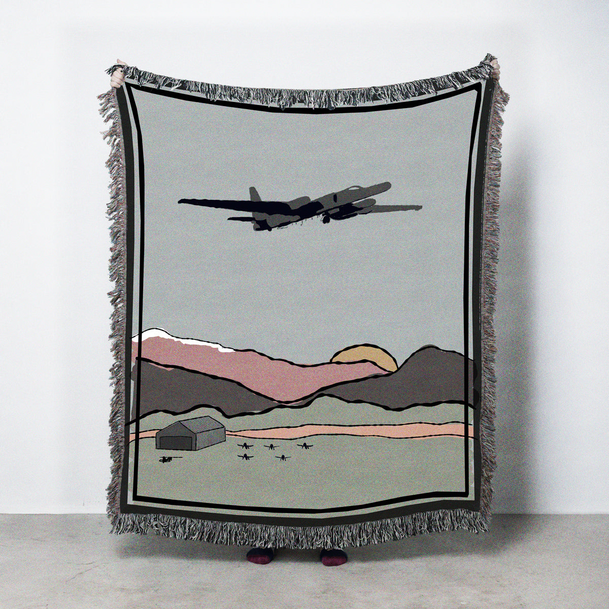 Woven blanket with Lockheed U-2 Dragon Lady flying over land