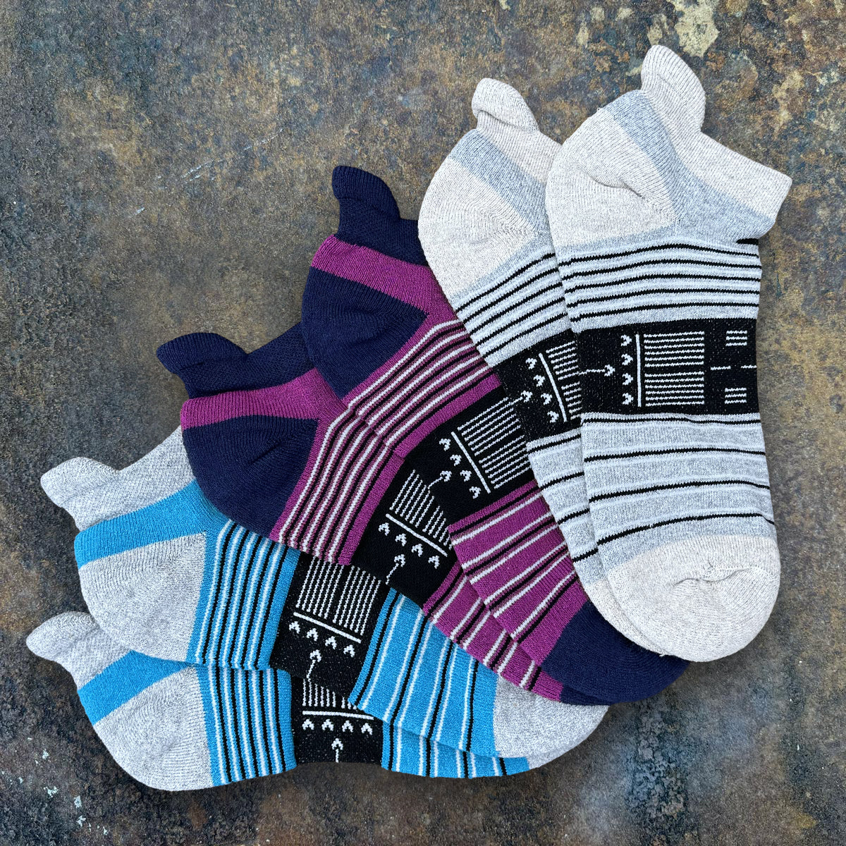 Three-pair bundle of aviation performance ankle socks featuring runway-inspired designs, moisture-wicking comfort, cushioned support, and pilot-themed artwork for aviation enthusiasts.