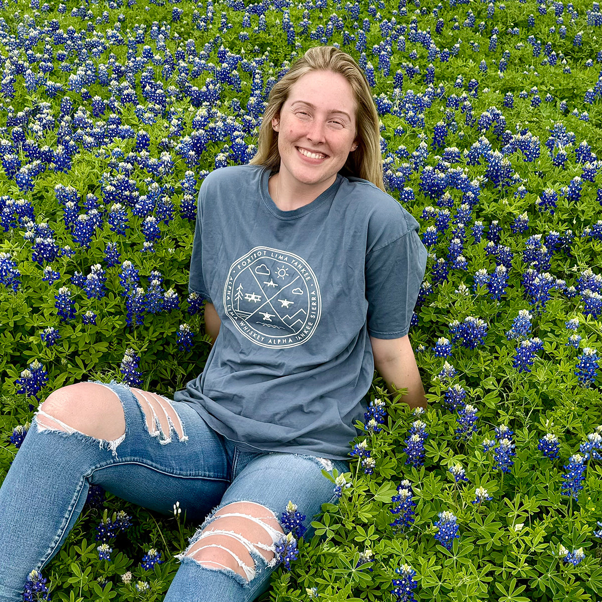 Short sleeve blue t-shirt with biplane, float plane, high wing airplane, low wing airplane, Fly Always in bluebonnets