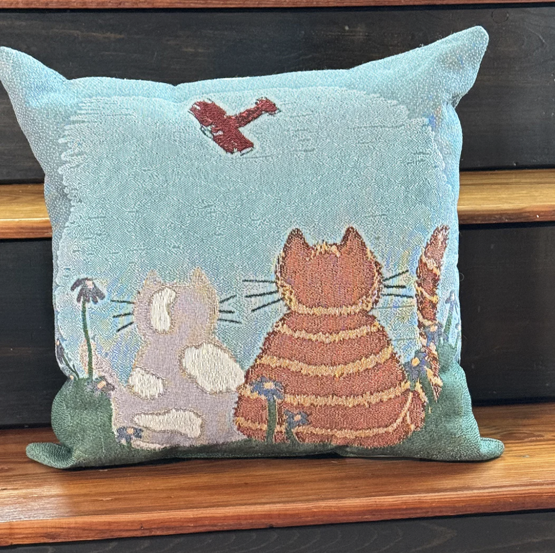 Woven pillow with cats watching airplane