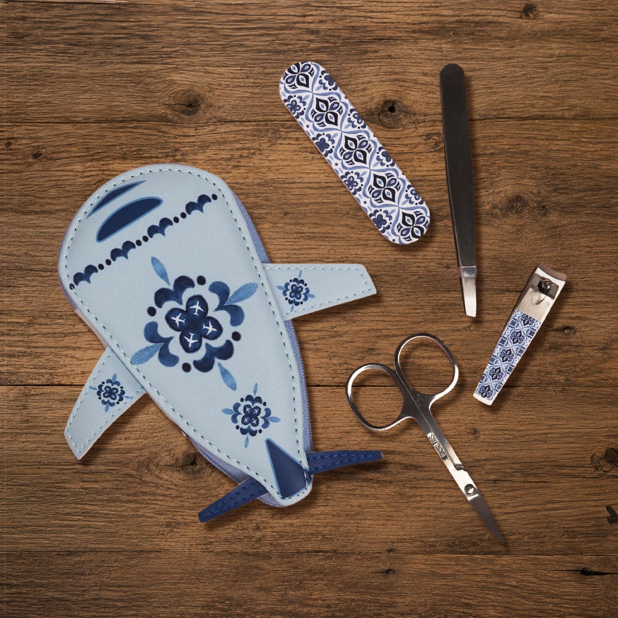 Airplane-shaped manicure set closed, showing aviation-themed travel grooming kit case