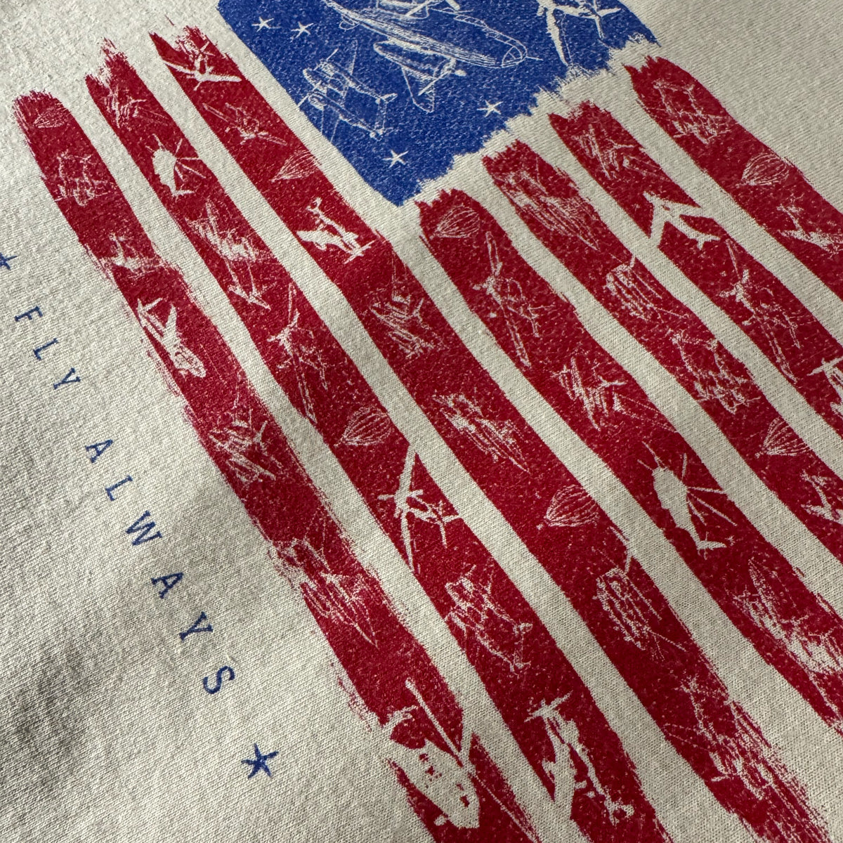 Closeup of America 250 airplane flag design t-shirt with the words fly always