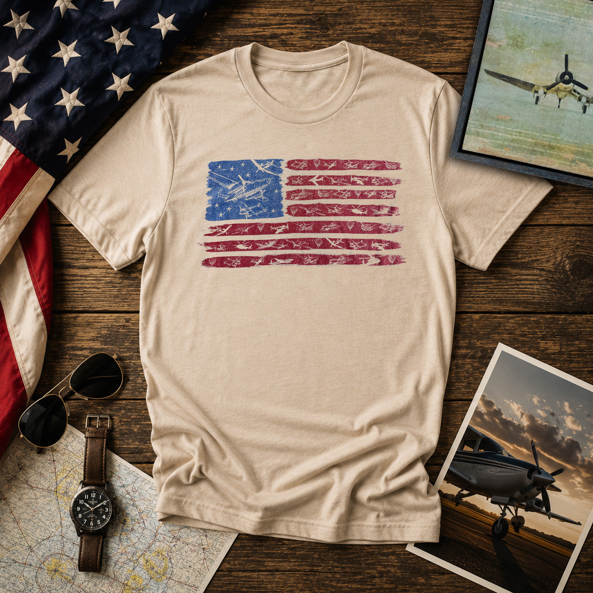 Beige t-shirt with American 250 flag design with airplanes on a wood background with USA flag