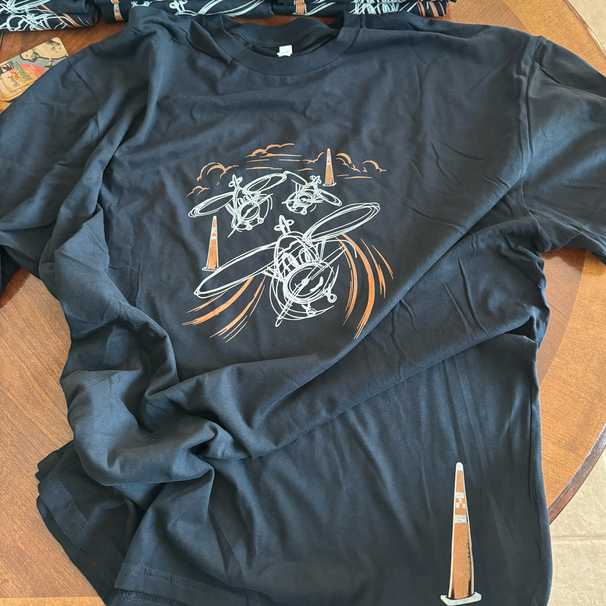 Around the Pylons Air Racing T-Shirt featuring three hand-sketched airplanes racing around pylons on a premium aviation graphic tee