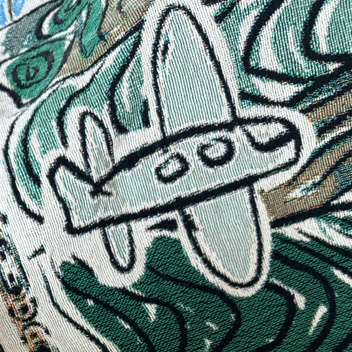 Decorative throw blanket close up with artistic design with airplane in flight