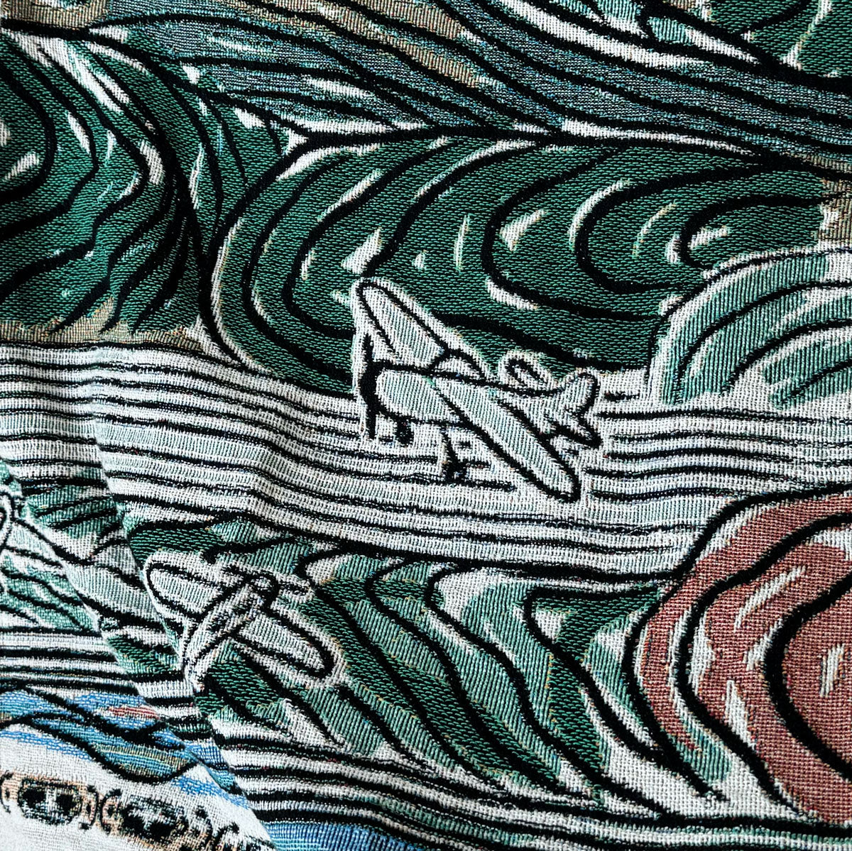 Decorative throw blanket close up with artistic design with airplanes taking off from a runway