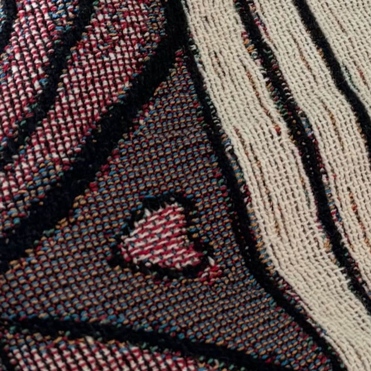 Decorative woven throw blanket close up with artistic design with heart