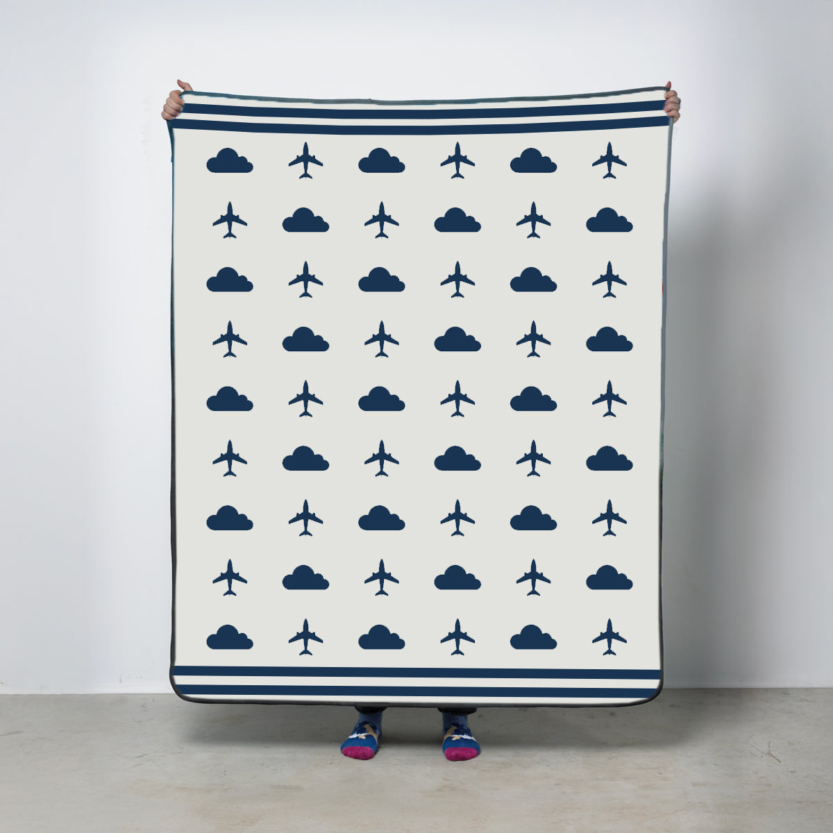 Fleece travel blanket with airplane and cloud pattern with white background