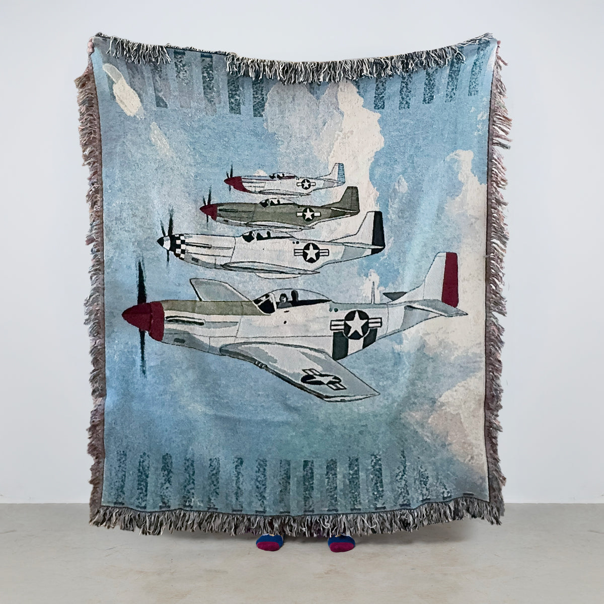 Woven blanket with vintage P 51 Mustang airplane with different paint schemes