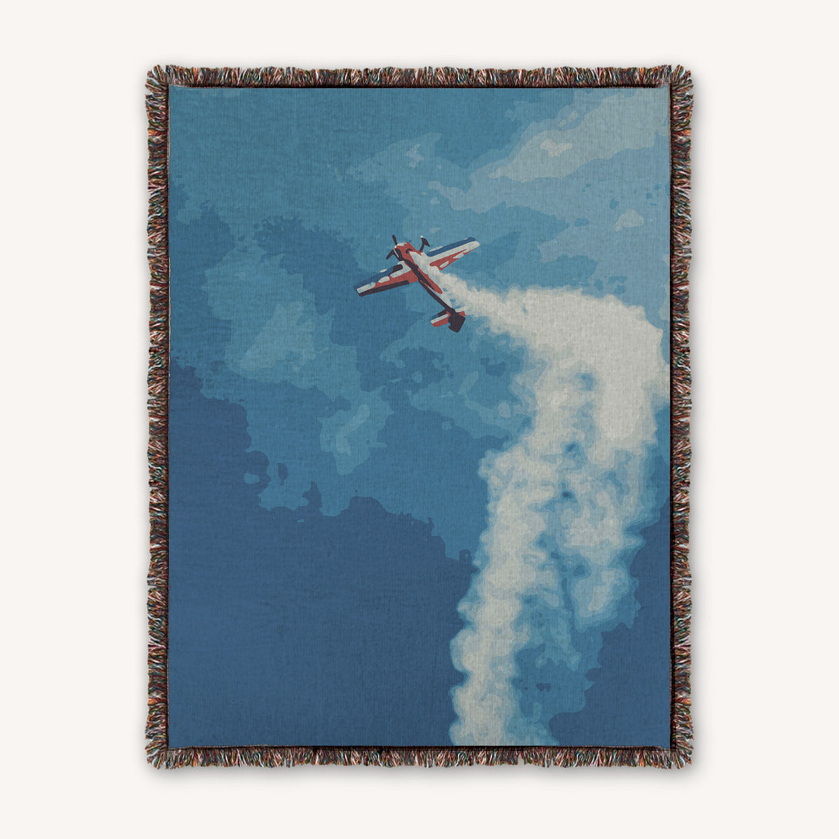 100% Cotton woven throw blanket with aerobatic airplane in the sky and clouds with smoke trail