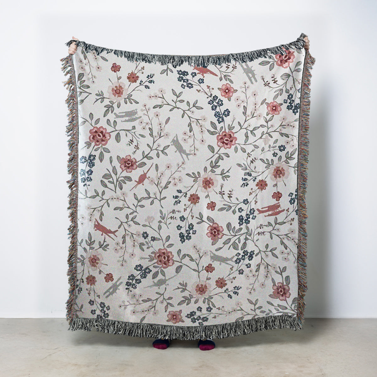 woven blanket with floral pattern and general aviation airplanes on a cream background