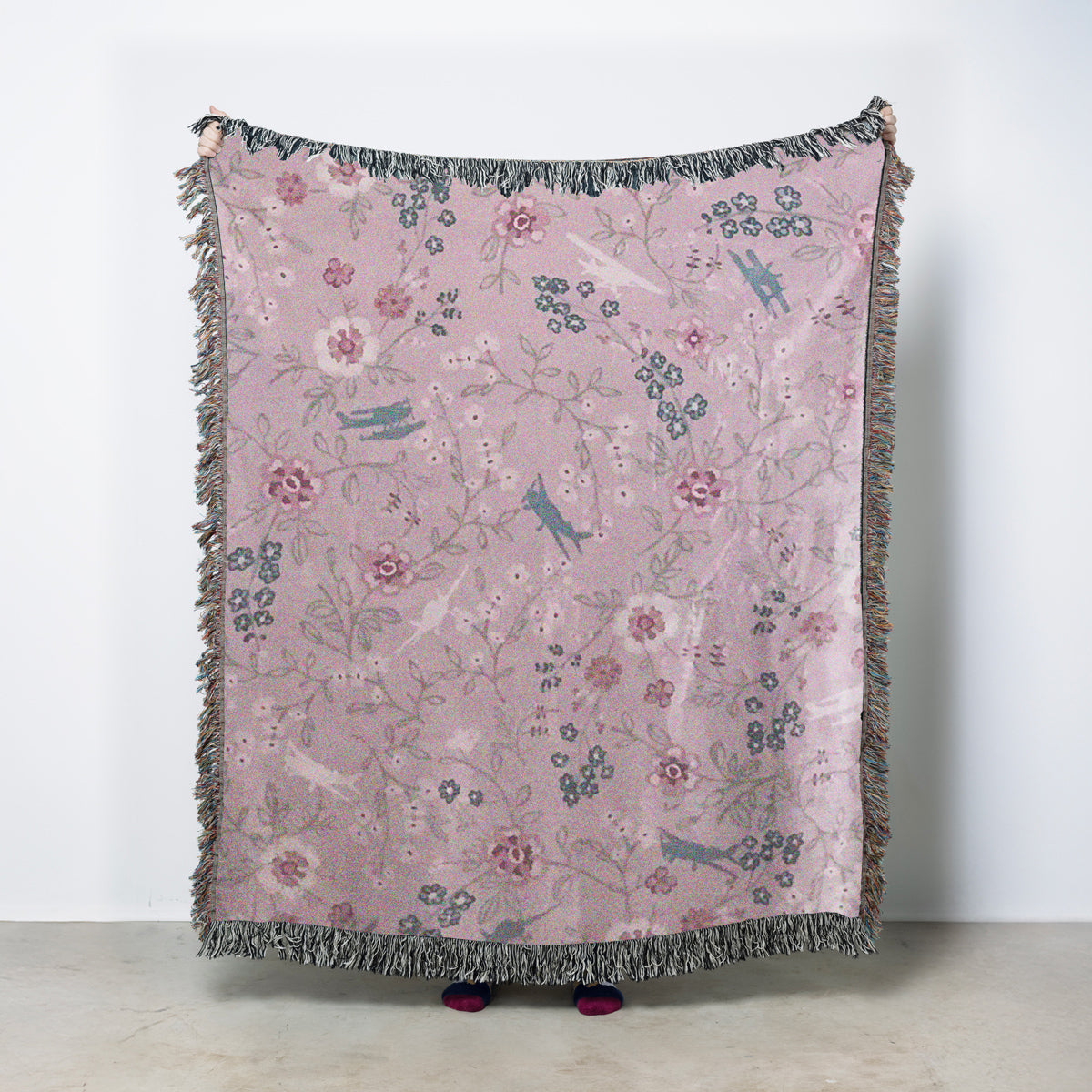 woven blanket with floral pattern and general aviation airplanes on a pink background
