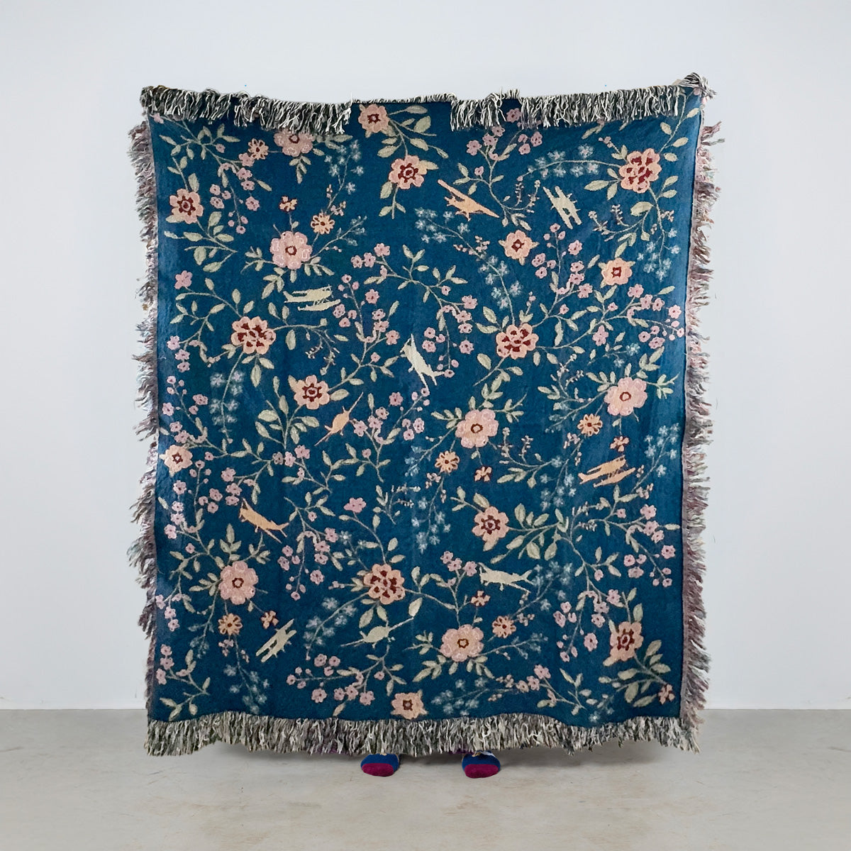 woven blanket with floral pattern and general aviation airplanes on a blue background