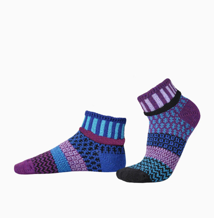 Pair of colorful patterned socks on a white background