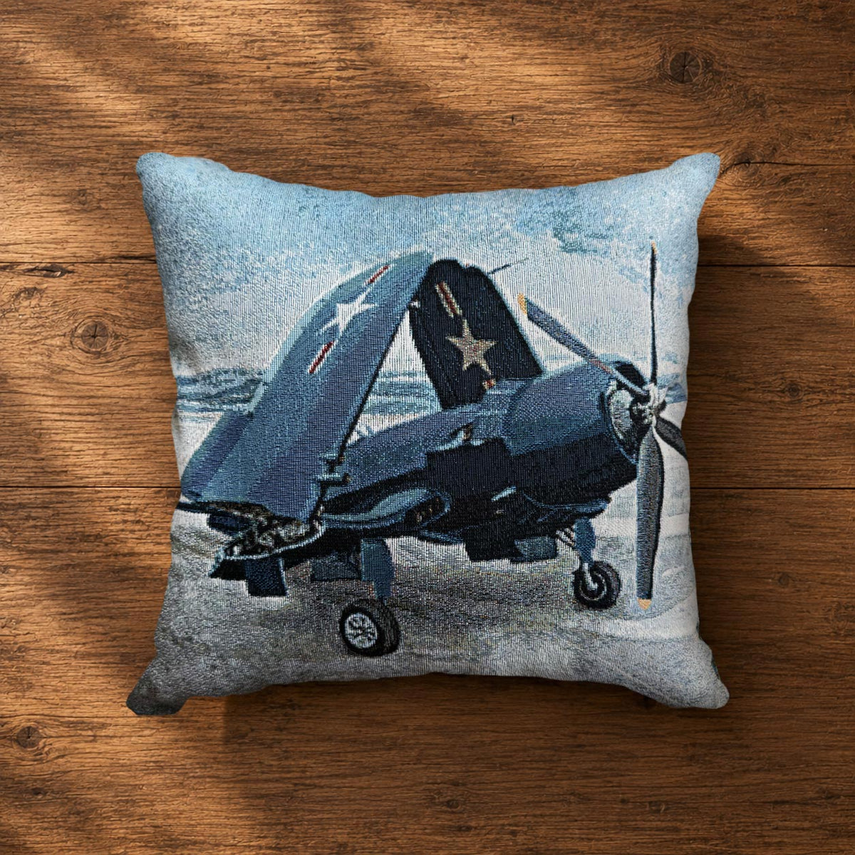 Woven pillow featuring a WWII Vought F4U Corsair fighter with its iconic folded wings on the deck of a U.S. Navy aircraft carrier, celebrating historic naval aviation.