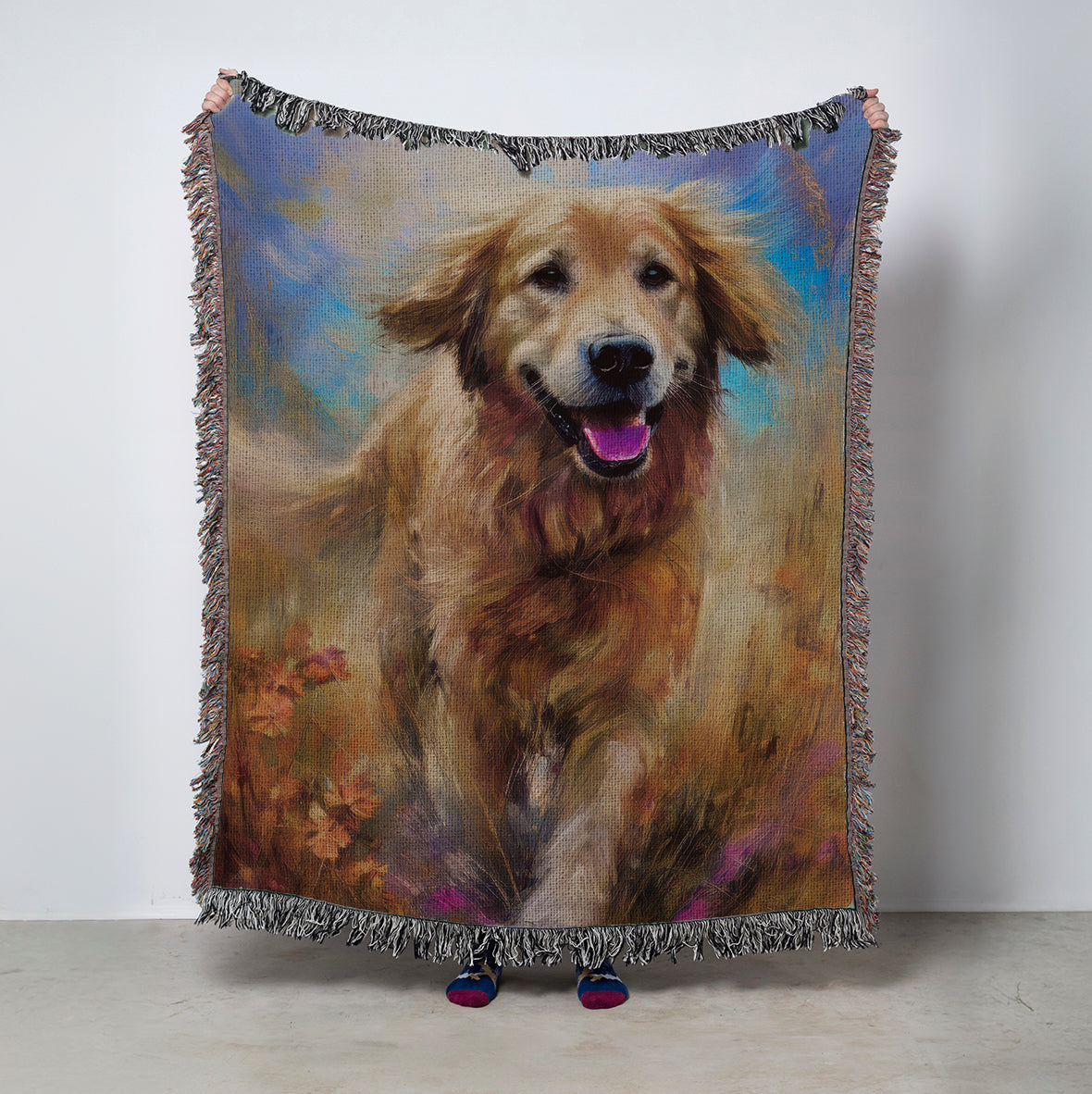 Woven blanket with an illustration of a golden retriever in a field and sky
